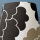 Small Space Age table lamp with a porcelain base and black and white flower shade.
