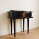 Vintage Art Deco bedside table in dark wood with gold details.