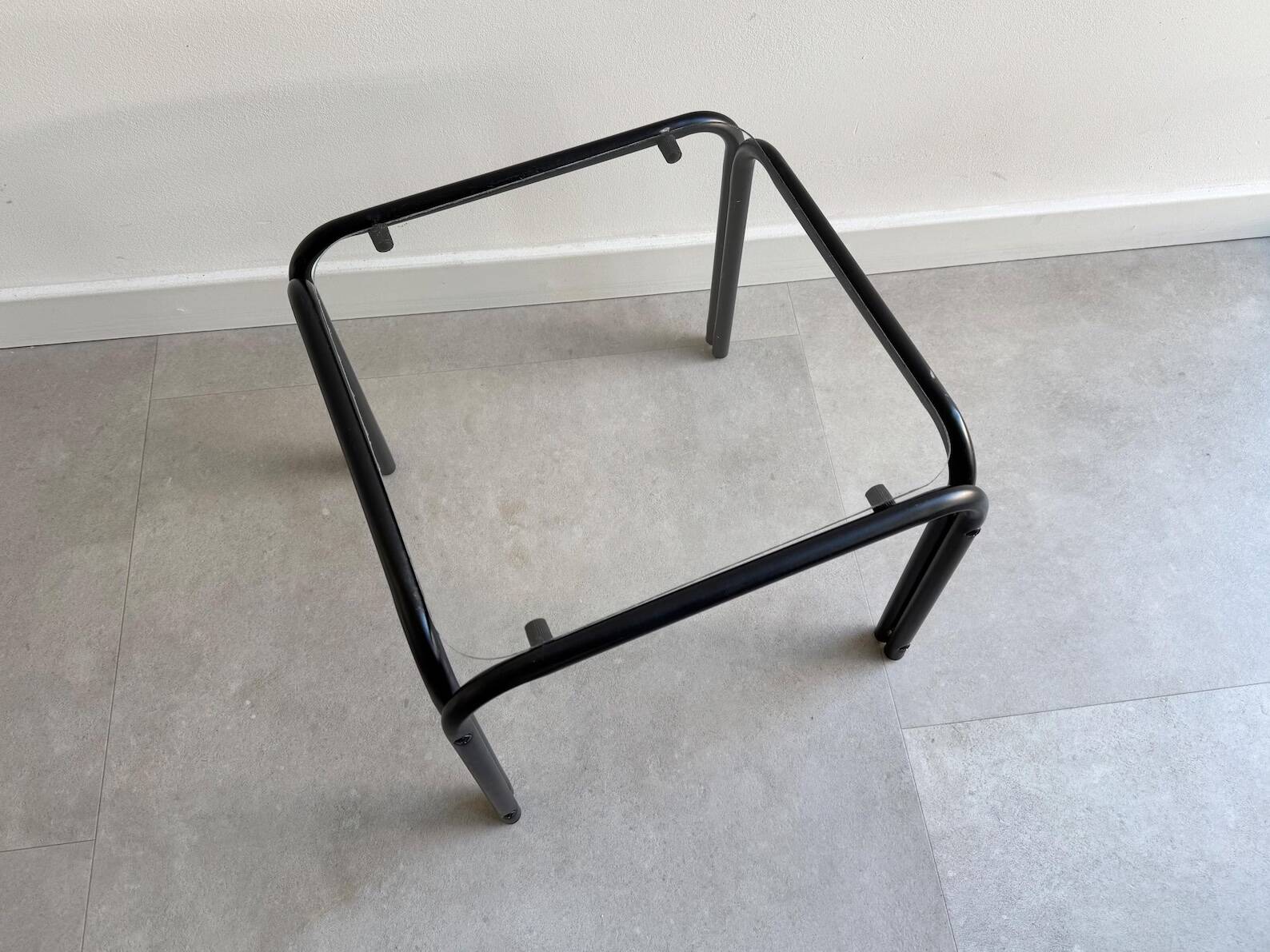 Vintage square black side table with a glass top