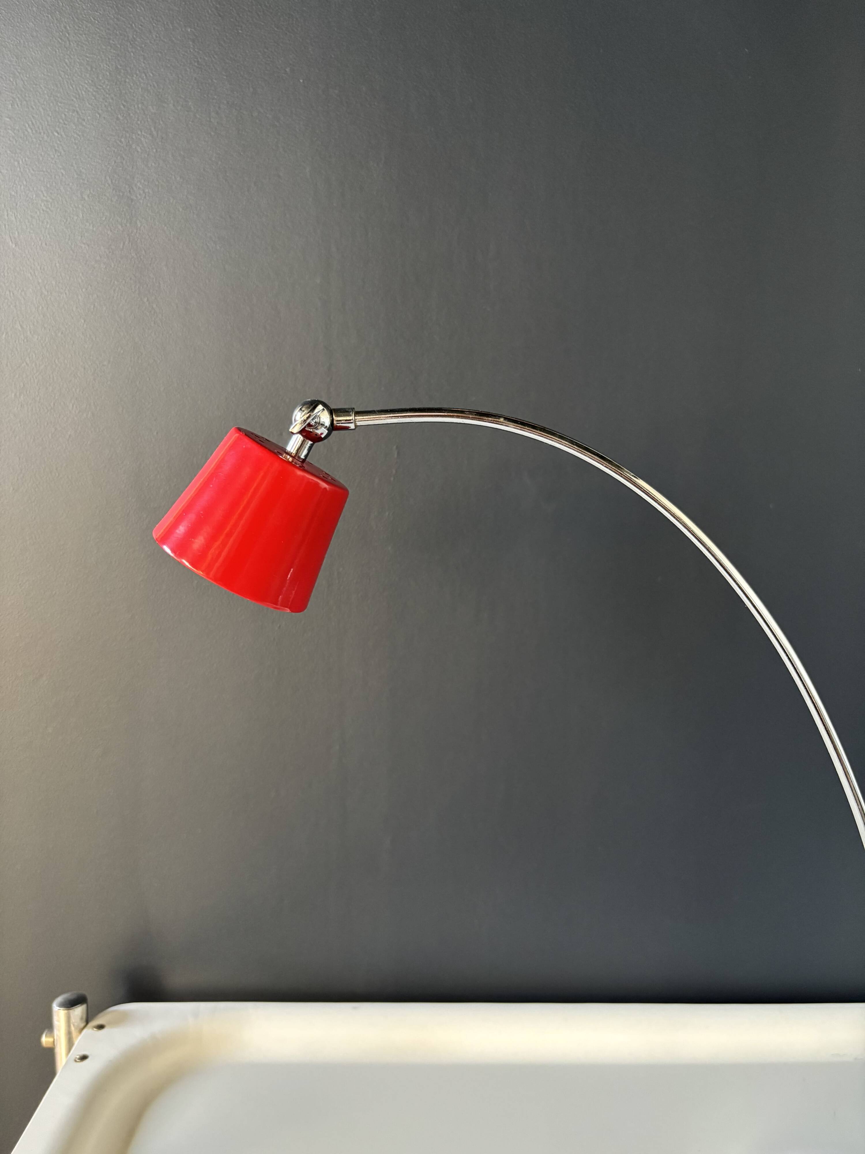 Vintage red lamp with a curved arm