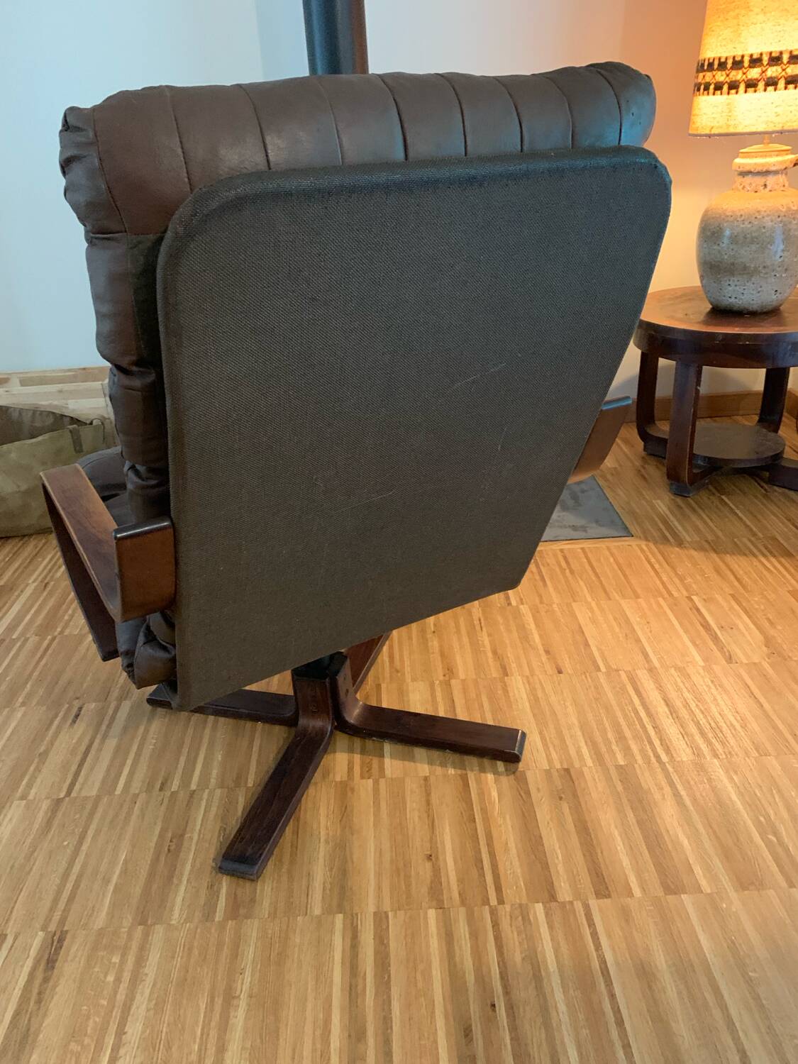 Vintage leather armchair with wooden armrests