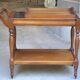 Serving table with a tray, on wheels, made of solid exotic wood.
