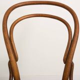 Bistro chair with curved wooden armrests and canning seat