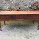 Old farmhouse table with cherry and chestnut panels with 3 drawers.