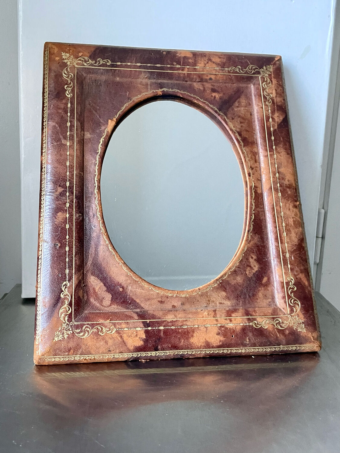 Antique leather framed mirror with gildings 30 cm x  24 cm