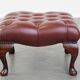In very good condition elegant red/brown chesterfield ottoman made of cow leather