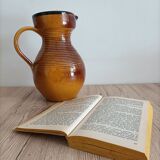Orange glazed ceramic pitcher
