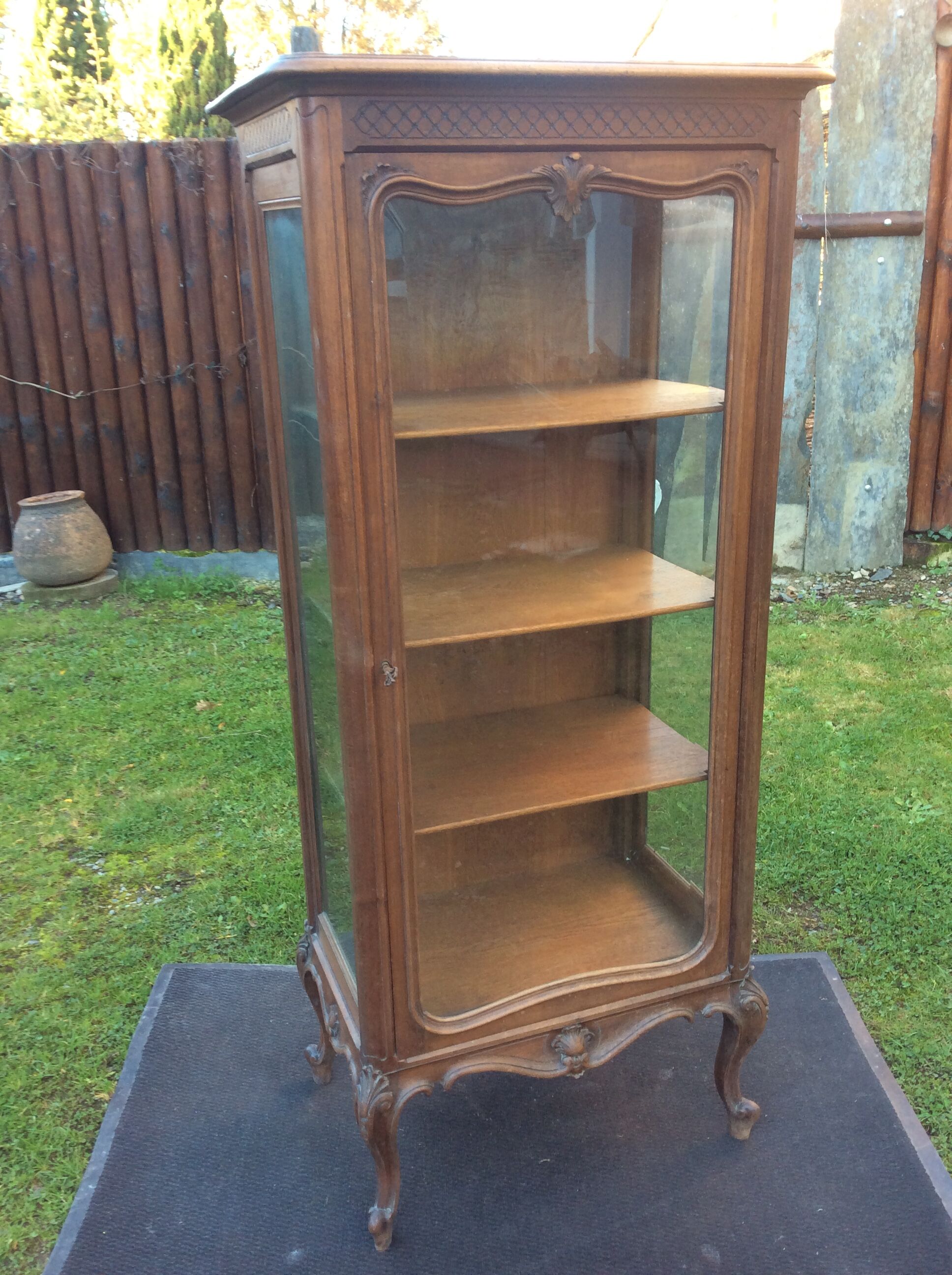 Louis XV Rocaille style showcase in solid walnut, beveled door glass.