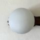Vintage table lamp hand-crafted in bronze with an opaline globe, Maison Arlus 1970.