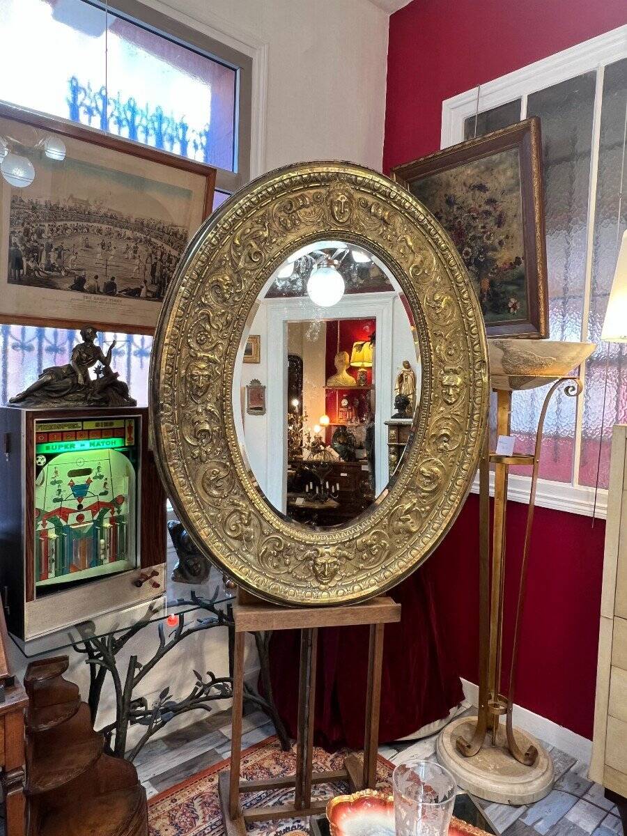 A. Arens, Antwerp, important oval mirror in repoussé brass with numerous animal decorations