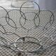 Fruit cut basket made of metal wire, ball feet