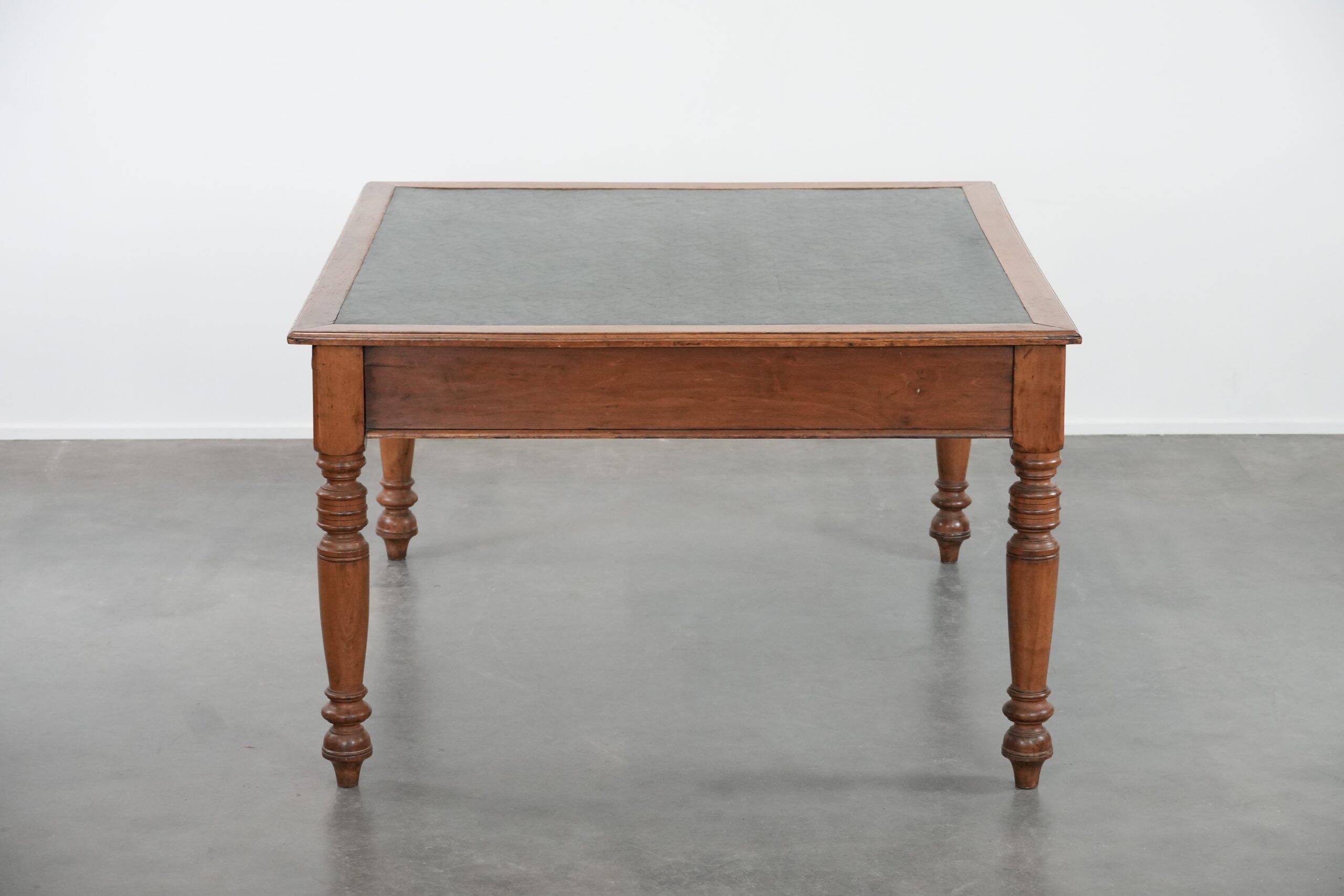 Antique writing table / partner desk with 4 drawers and a green leather top