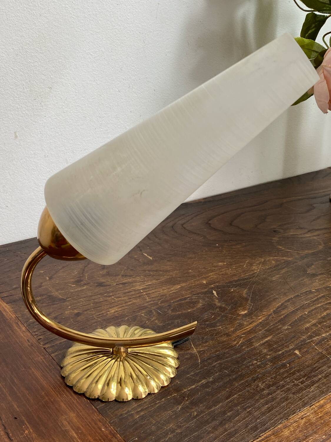 Gold metal wall light with ribbed glass.