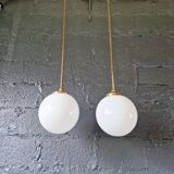 Pair of Art Deco pendant lights in brass and white opaline, 1920-30