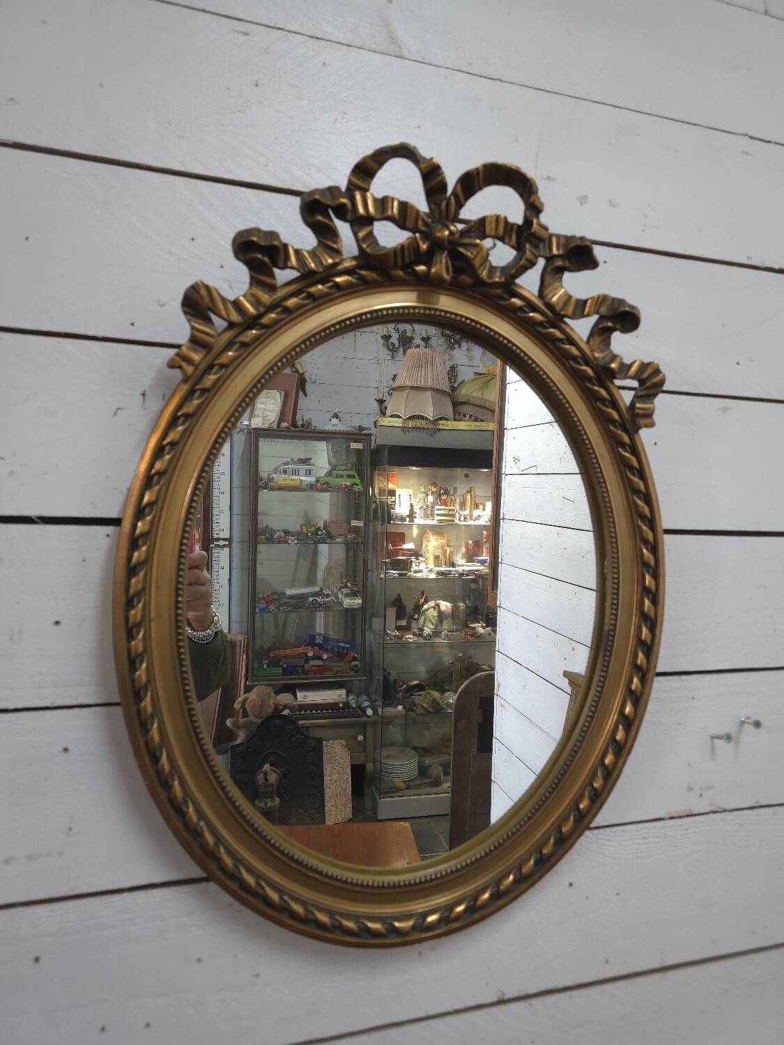 Oval mirror with gold patina