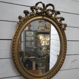 Oval mirror with gold patina
