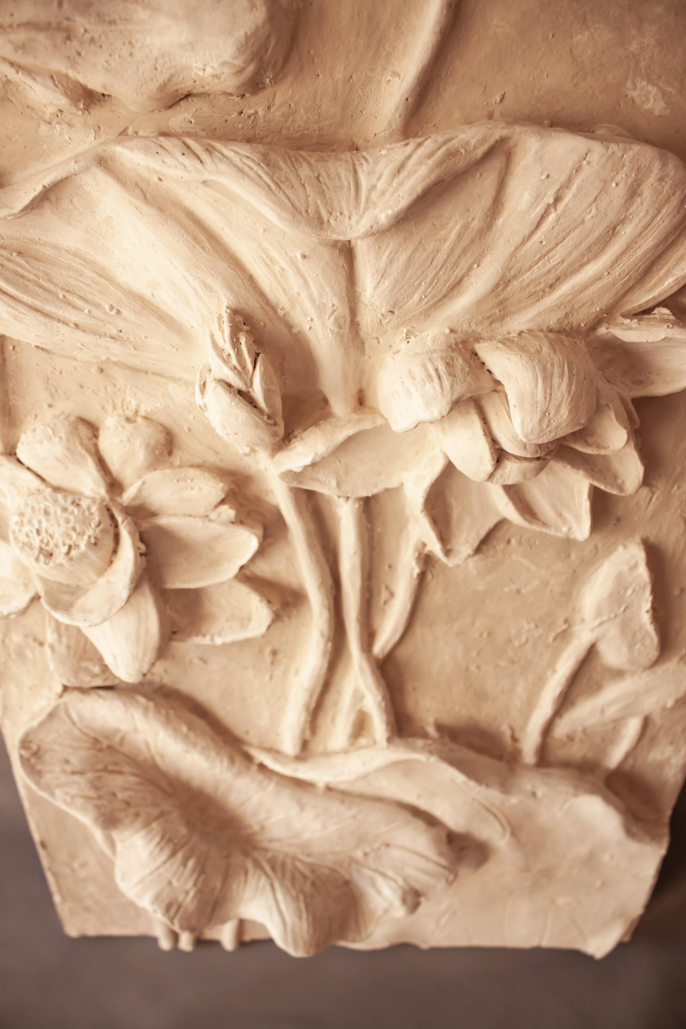 Relief with flowers. Bas-relief with flowers. Relief with flowers. Flowers in relief.
