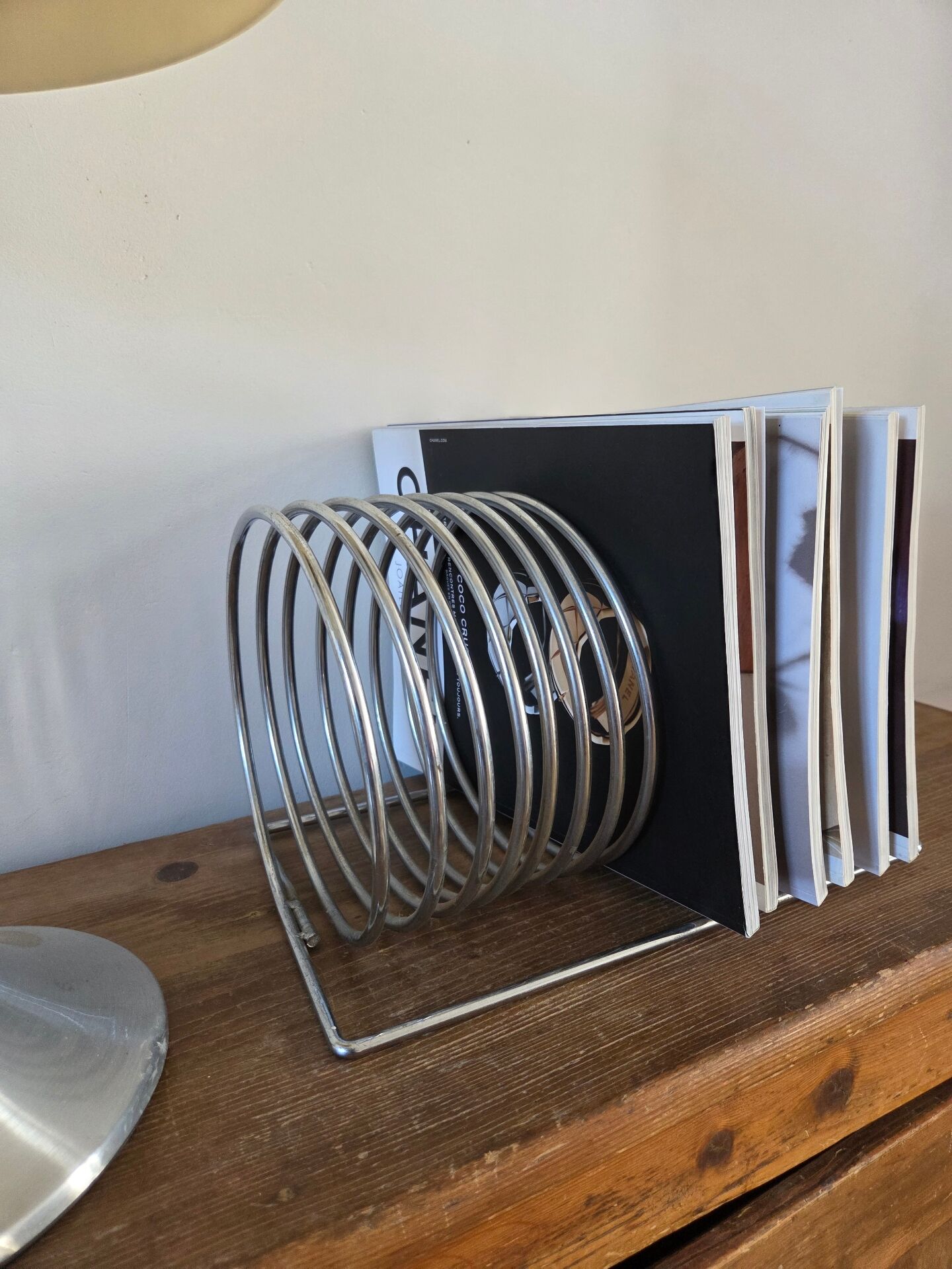 Chrome spring magazine rack, 1970