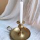 Large hand candlestick in gilded brass