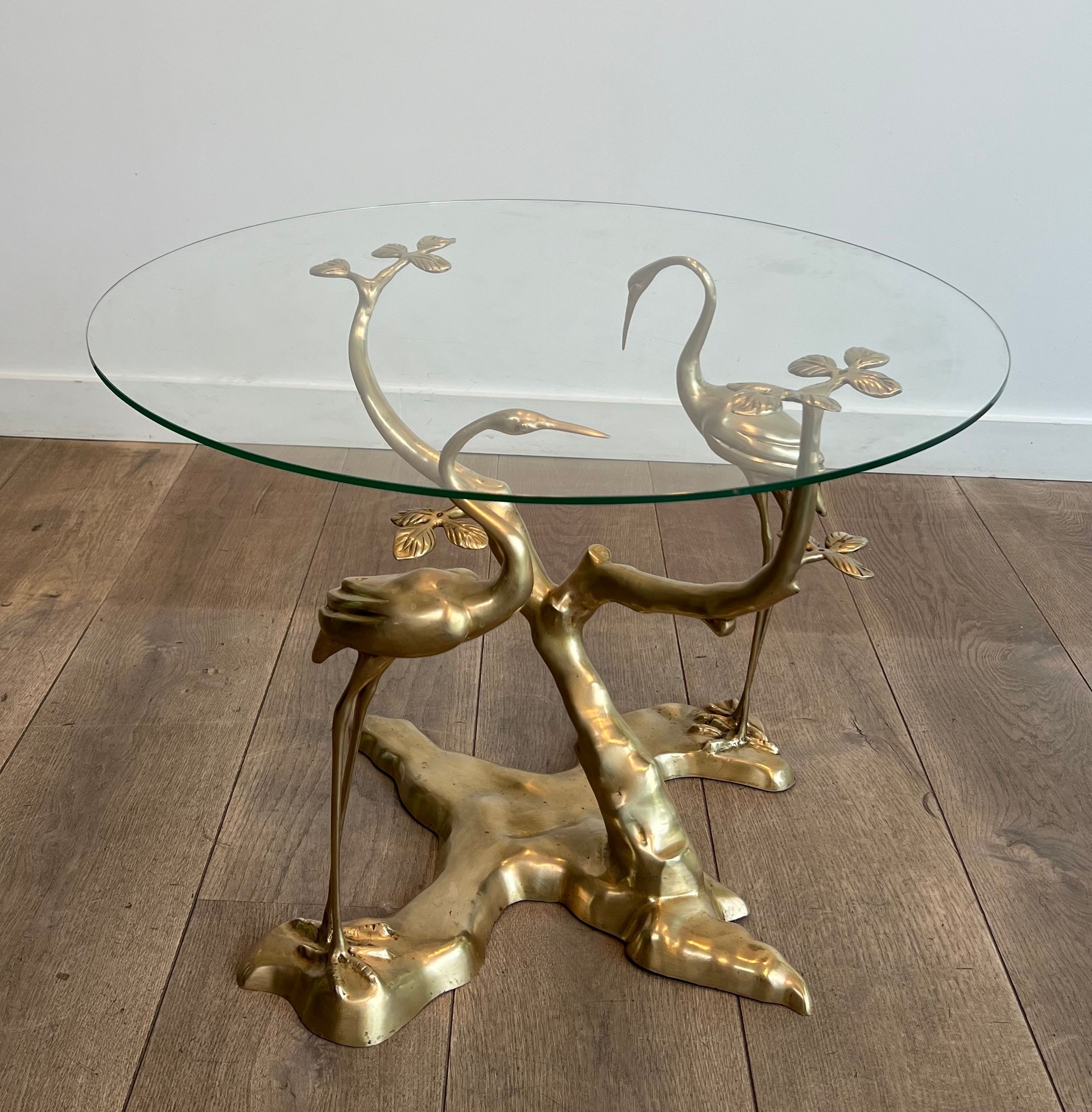 Coffee table model with cranes surrounding a brass bonsai and round glass top by Willy Daro.