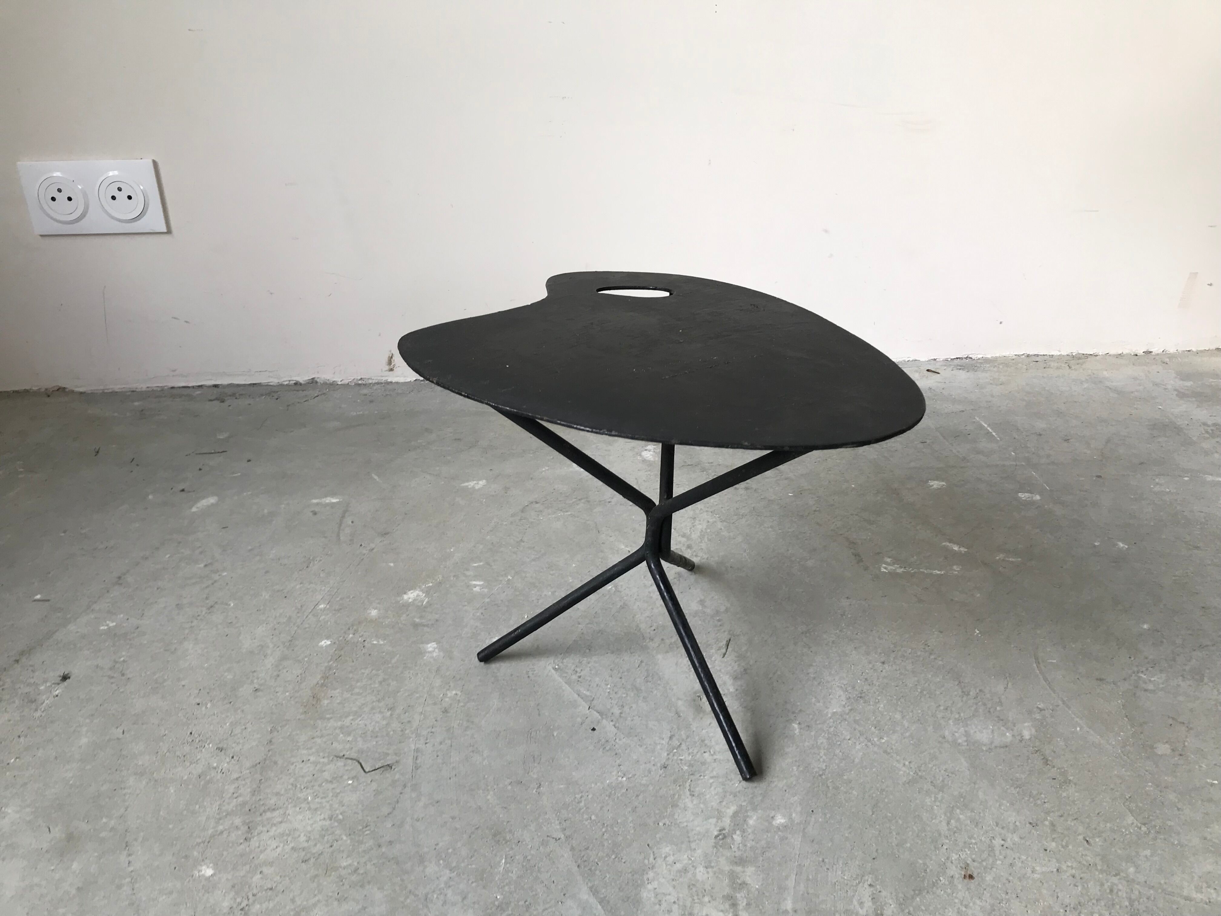 Side table in black lacquered metal, circa 1950.