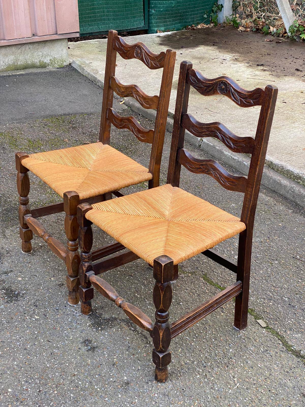 2 solid wood chairs with carved rush seats