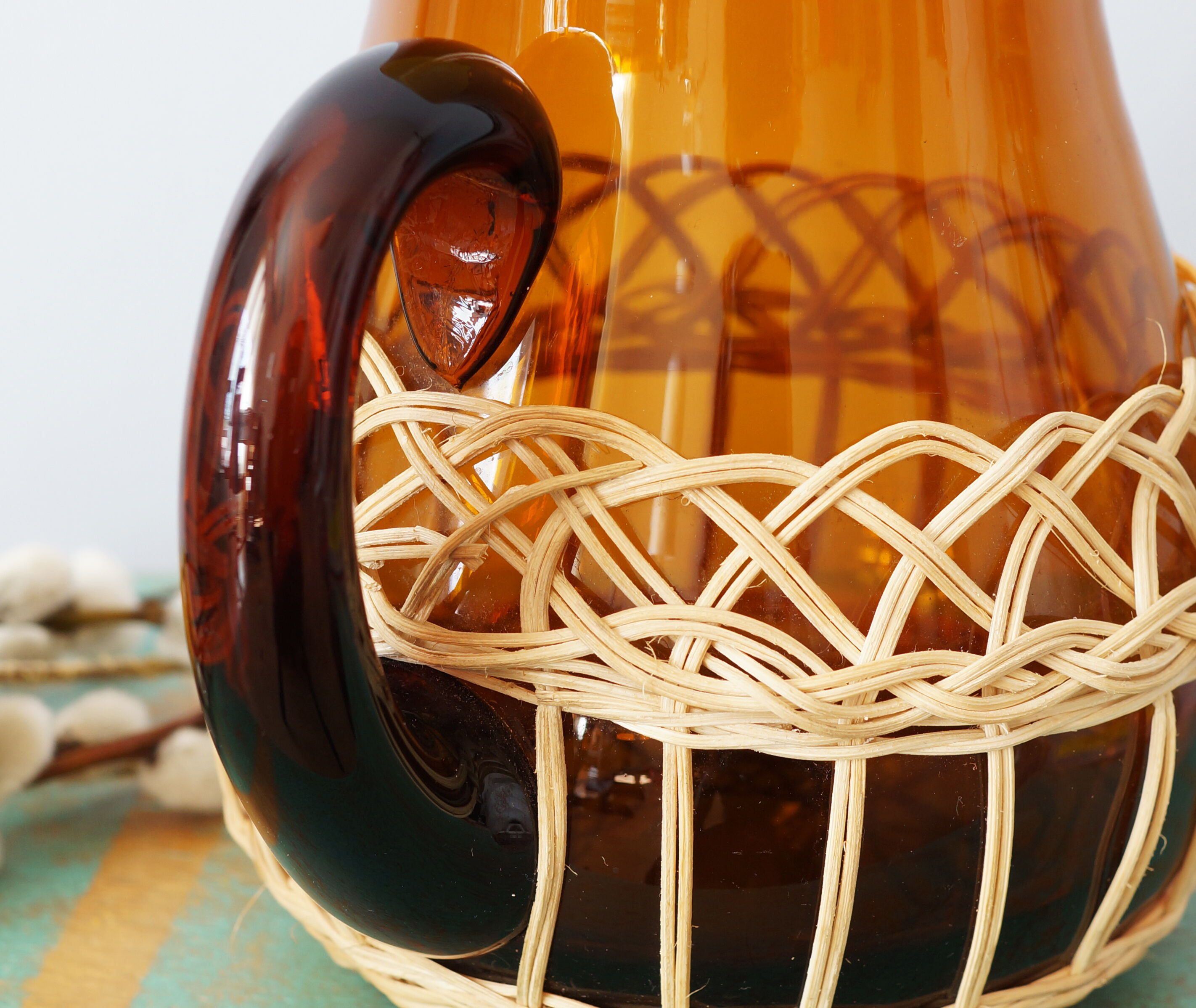 Amber glass decanter dressed in wicker, vintage
