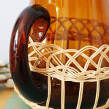 Amber glass decanter dressed in wicker, vintage