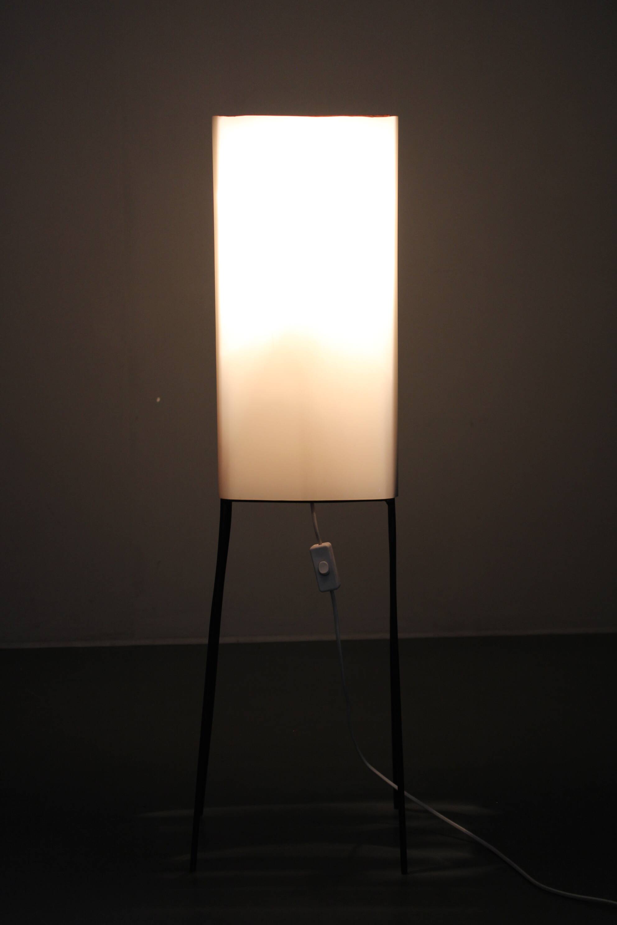 Mid-century modern floor lamp on iron legs with plastic shade and wood accent
