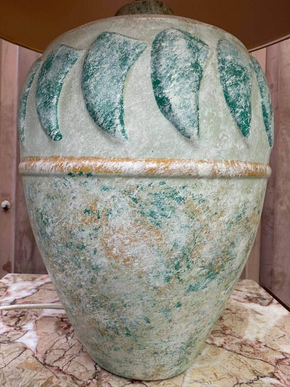 Vintage green ceramic table lamp with a worn lampshade.