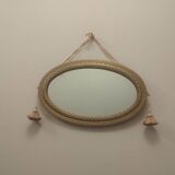 Oval mirror in wood and gilded plaster with pompom decoration