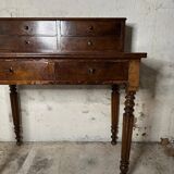 Wooden lady's desk says "happiness of the day"