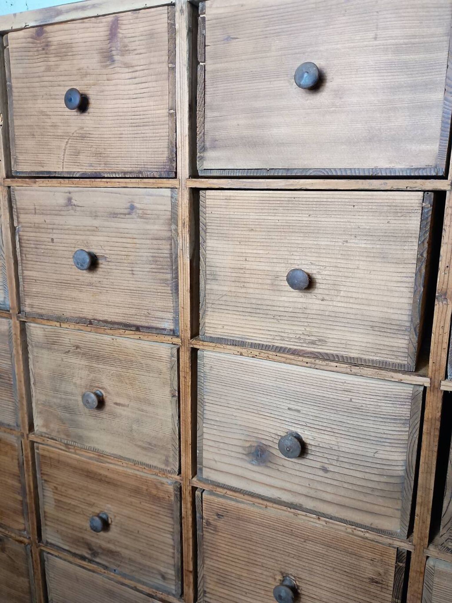 Industrial or apothecary workbench with 30 vintage wooden drawers.