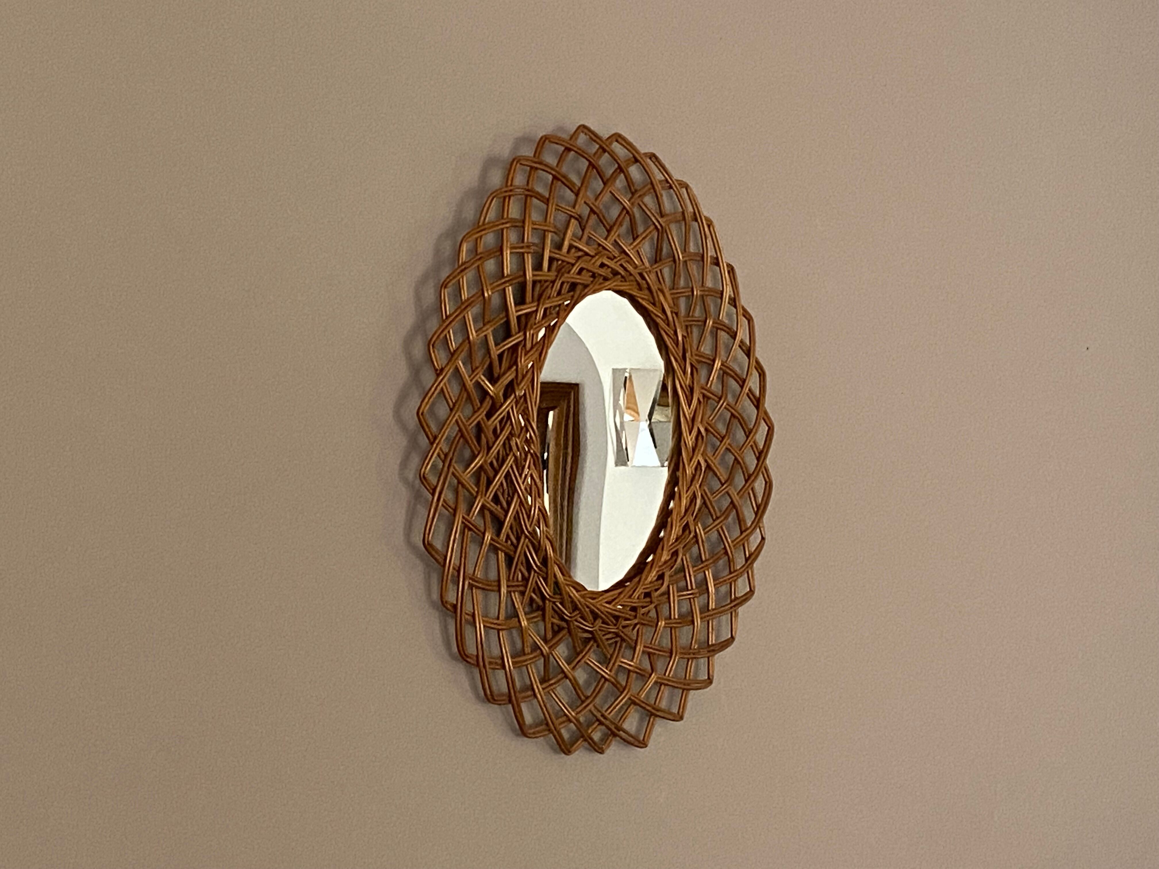 Sun mirror in woven rattan. 1960.