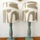 Pair of wooden lamps with custom modernist lampshades.