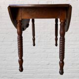 Oval walnut table with flaps