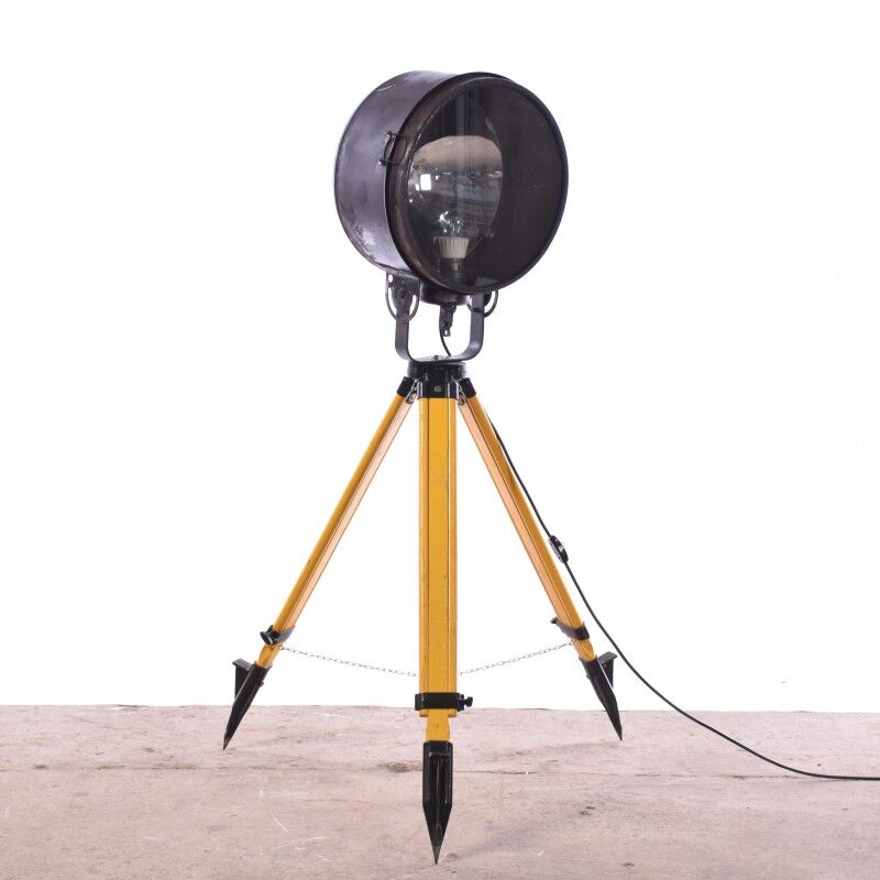 Old industrial spot on wooden tripod