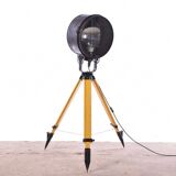 Old industrial spot on wooden tripod