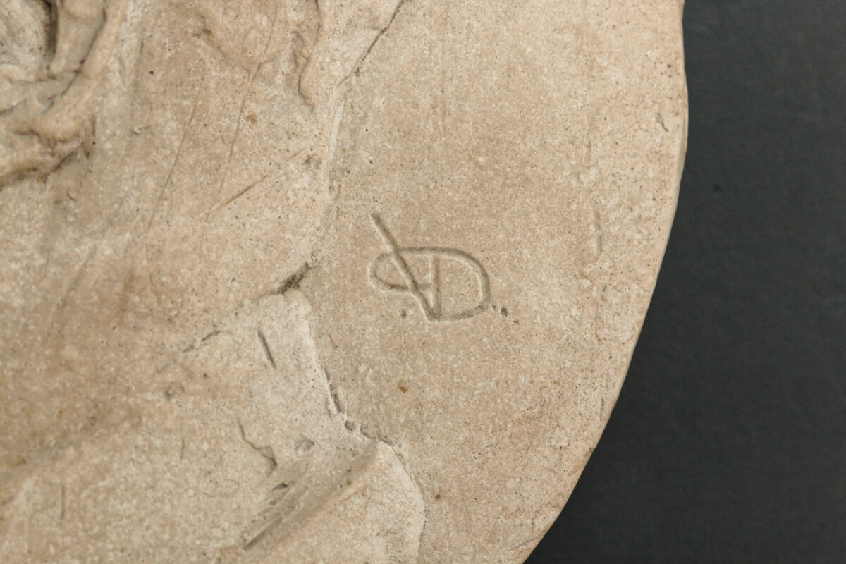 Old plaster medallion, man profile