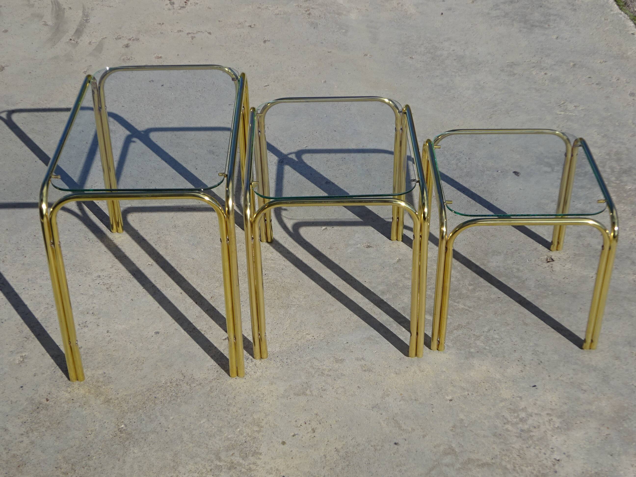 Nesting tables in gold-tone metal and glass