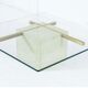 Coffee table with travertine gold-plated cross base and glass top