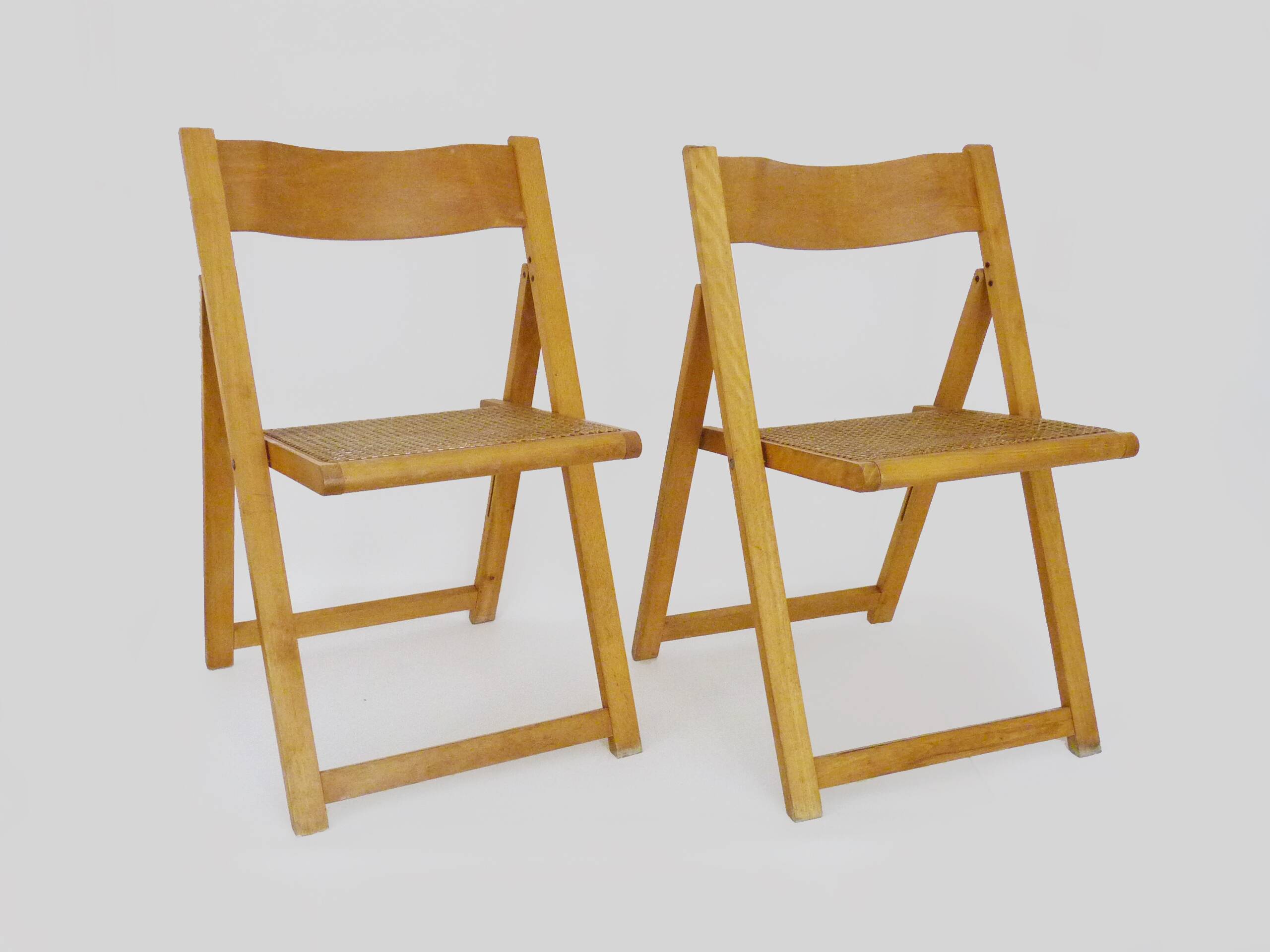 Pair of vintage folding chairs in beech and canework. Italy 70s