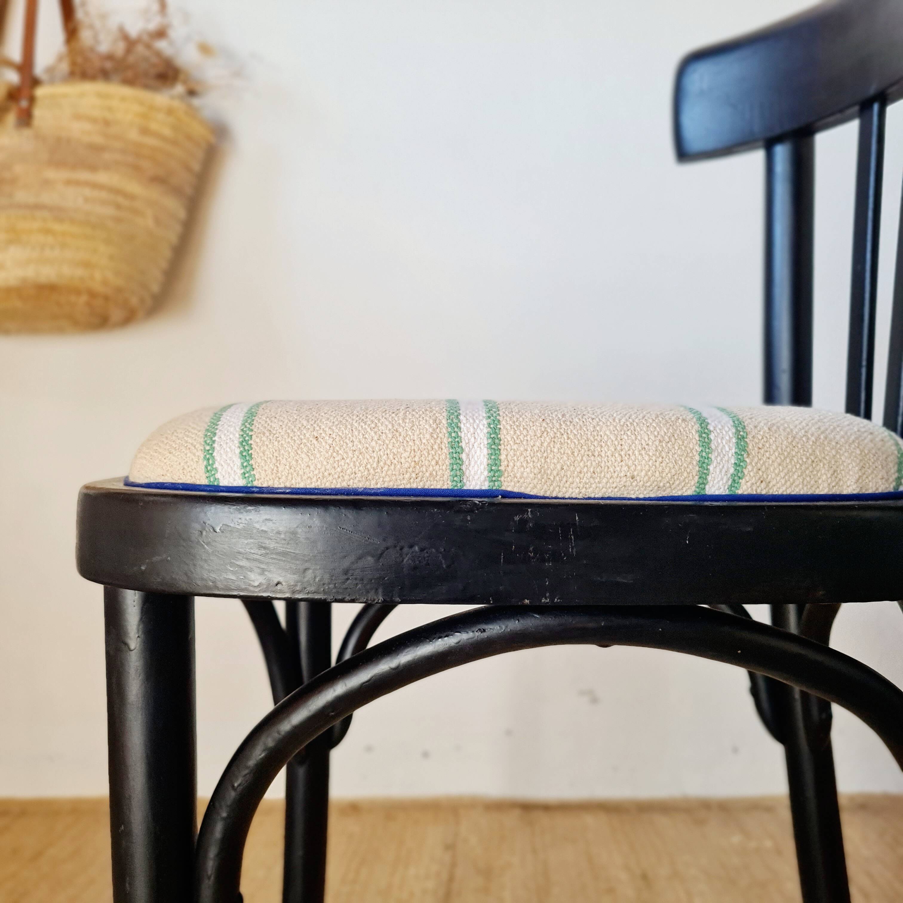 Curved black wooden bistro chair with striped seat