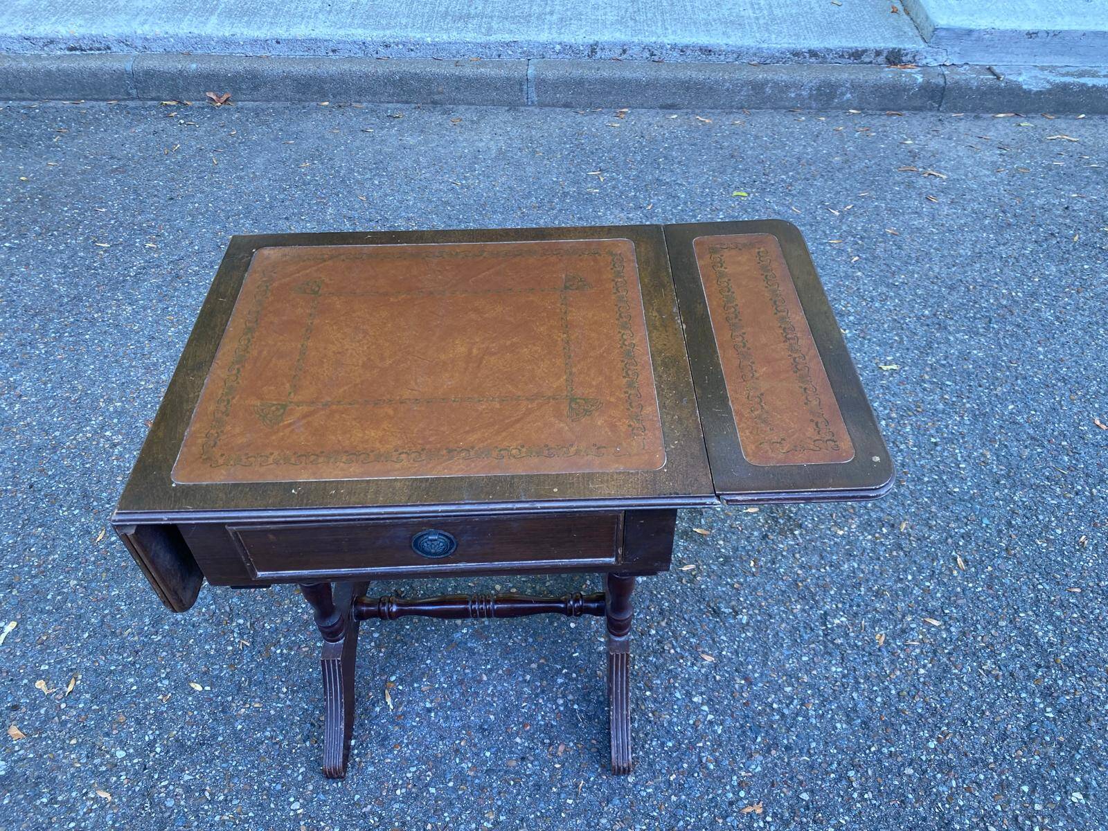 Small drop-leaf side table in English style with leather top & drawer.