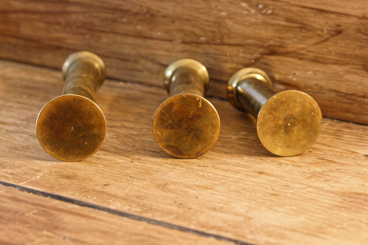 Trio of brass candle holders