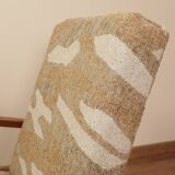 Pair of vintage lounge chairs in brown jacquard fabric and wood.