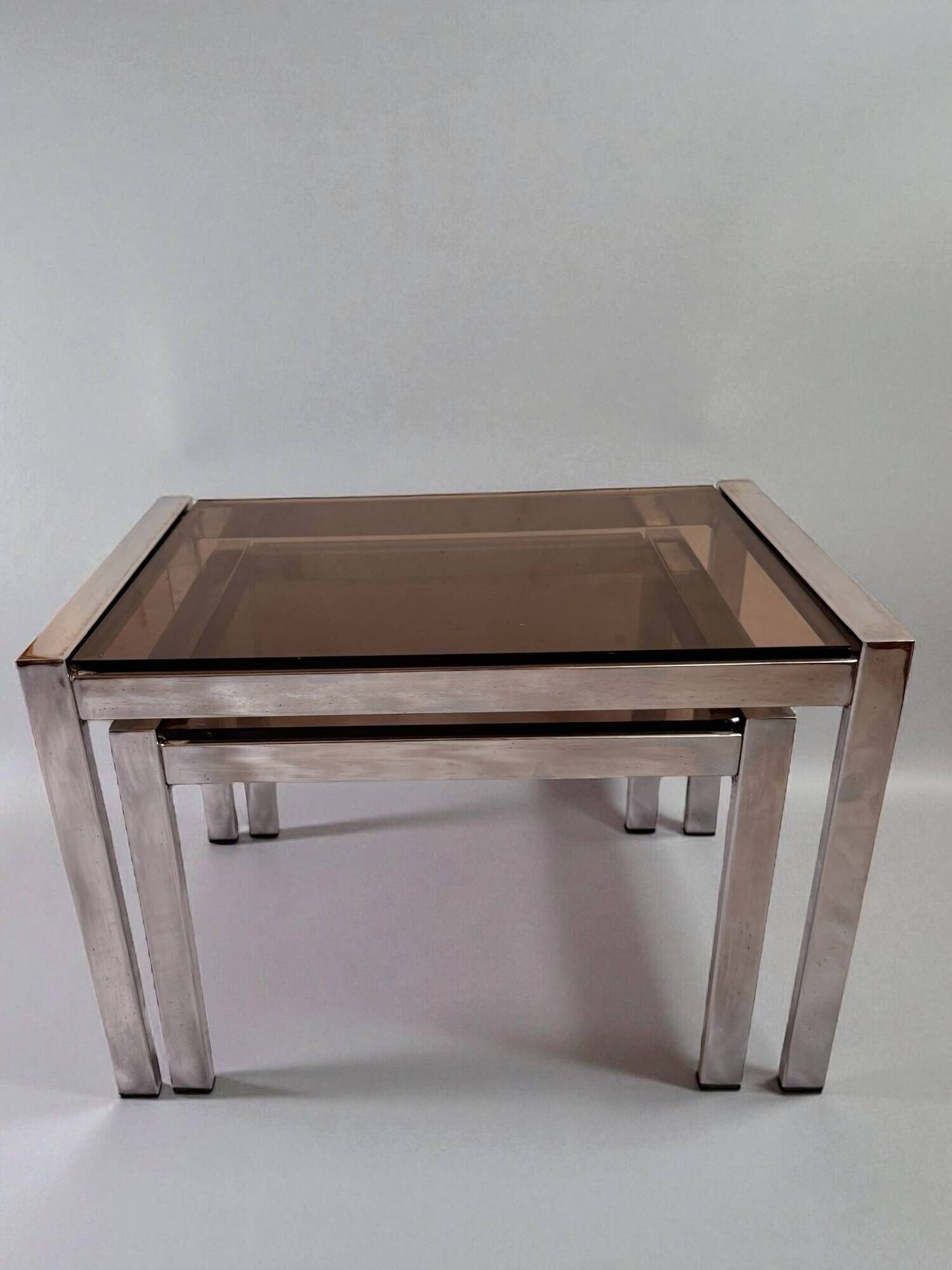 Vintage nesting tables from the 1970s, chrome and smoked glass, mid-century modern.