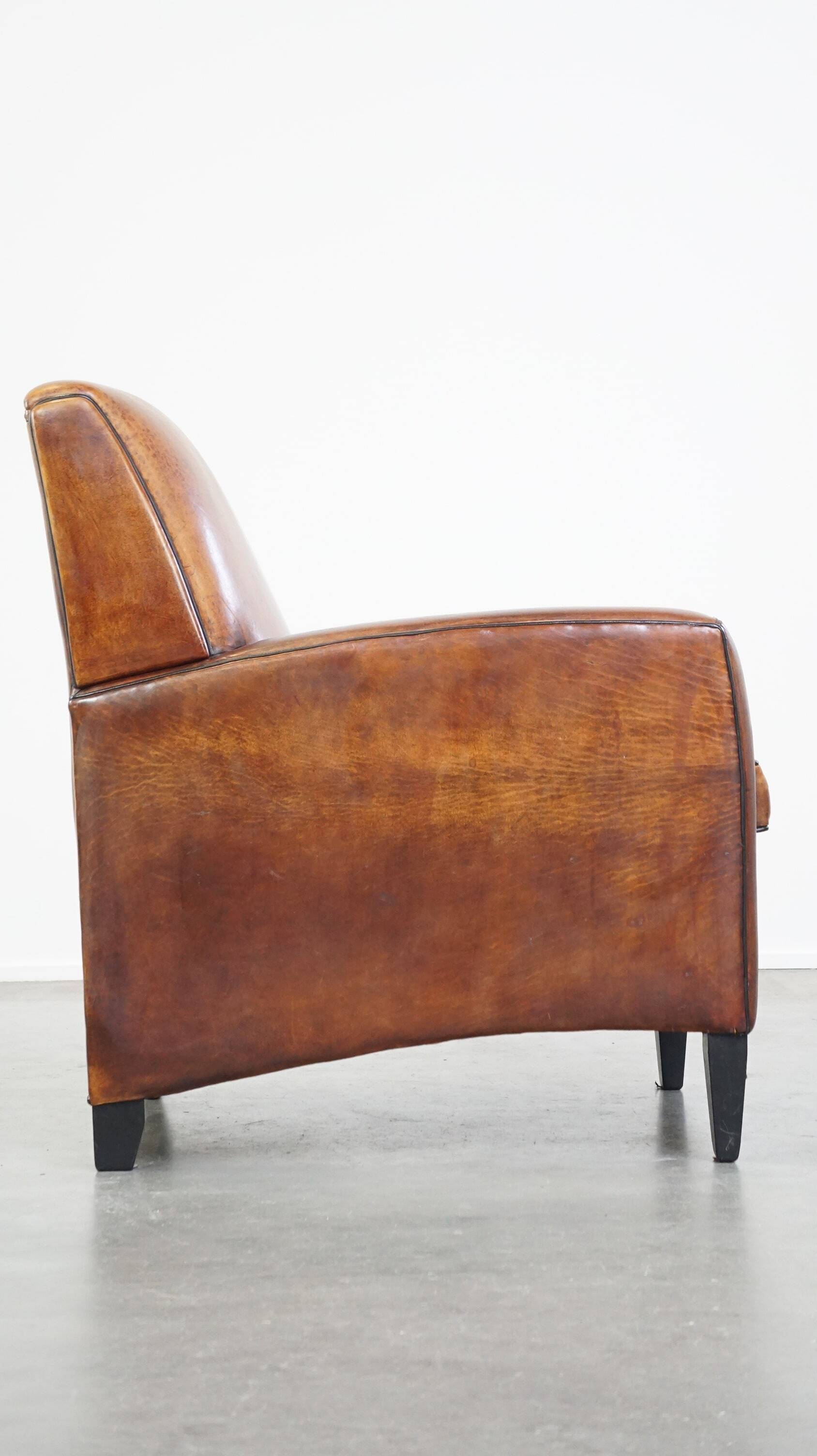 Art Deco design sheepskin leather armchair with a stunning patina