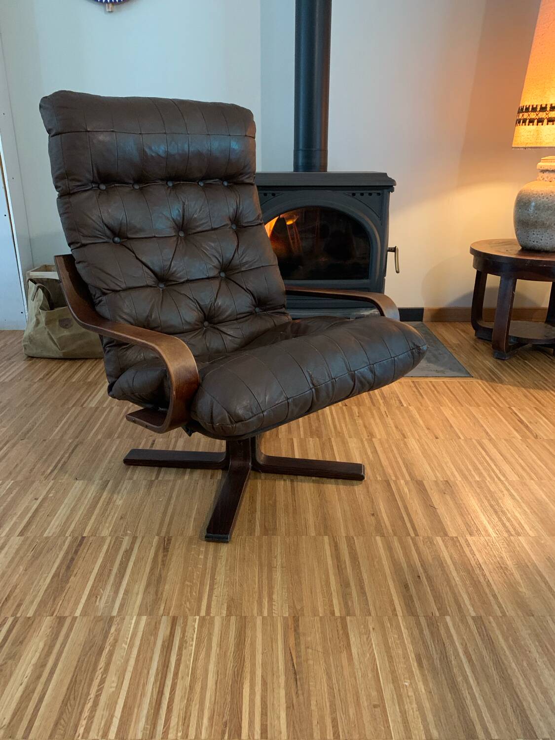 Vintage leather armchair with wooden armrests