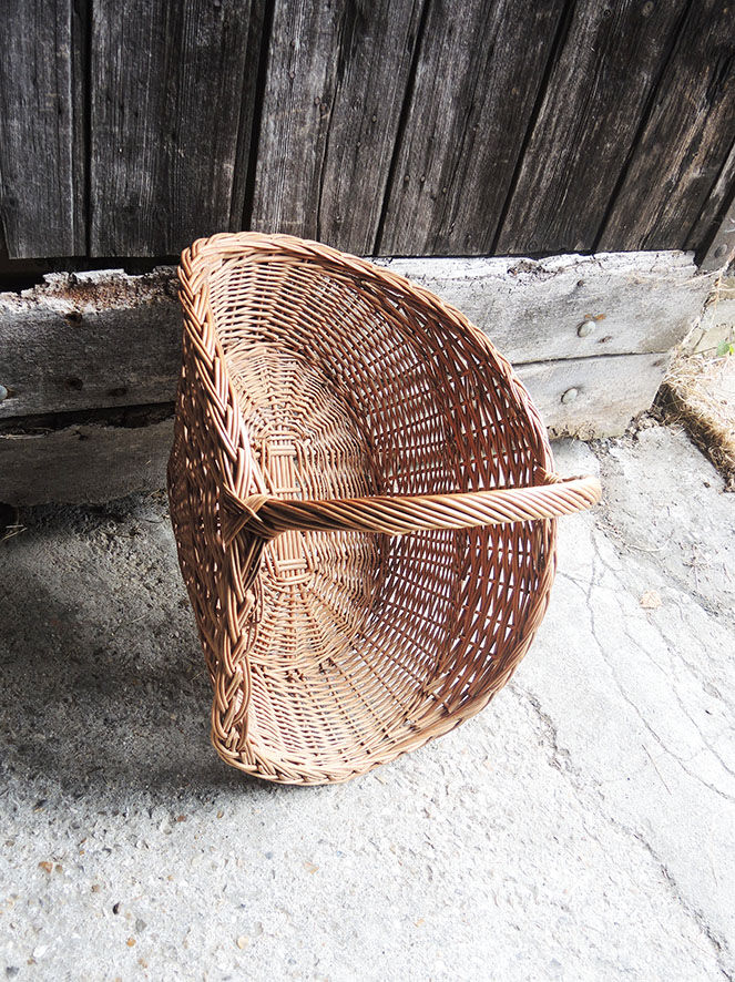 Old basket with logs in light wicker